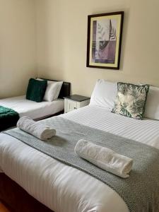 a room with two beds with towels on them at Apartment 14 in Aberystwyth