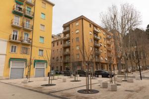 a row of poles in a courtyard in front of buildings at Archi di Vesna II in Ancona
