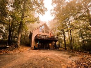 a cabin in the middle of a forest with trees at A-Frame @ WTG Resort w/ Hot Tub in Mount Torry Furnace