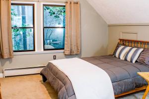 a bedroom with a bed and a large window at A-Frame @ WTG Resort w/ Hot Tub in Mount Torry Furnace