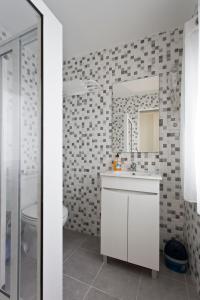 a bathroom with a white sink and a mirror at Braganca Oporto in Porto