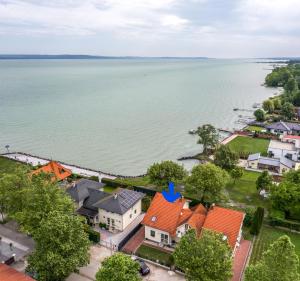 an aerial view of a town with houses and the water at Villa Gabriella - Vízparti in Balatonboglár
