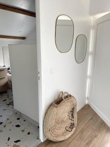 a room with two mirrors on the wall and a bag at Casa Familia in La Teste-de-Buch