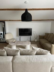 a living room with a couch and a tv at Casa Familia in La Teste-de-Buch +16 photos