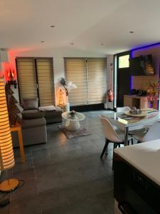 a living room with a couch and a table at Riviera Cottage in Comblain-au-Pont