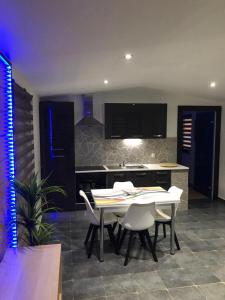 a kitchen with a table and chairs in a room at Riviera Cottage in Comblain-au-Pont