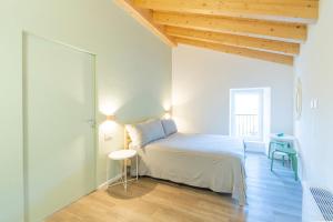 1 dormitorio con 1 cama en una habitación con techos de madera en B&B La Volpe, en Moneglia
