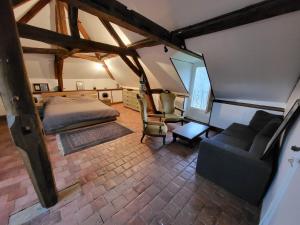 an overhead view of a bedroom with a bed and a couch at Les Oiseaux de Passage in Escolives-Sainte-Camille