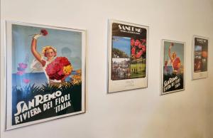 a group of posters on a wall at CLASSY HOMES - A due passi dal mare in Sanremo +11 photos
