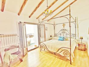 a bedroom with a bed and a large window at Villa Carabeo in Nerja