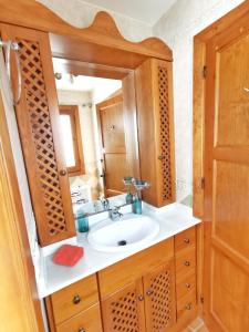 a bathroom with a sink and a mirror at Villa Carabeo in Nerja +46 photos
