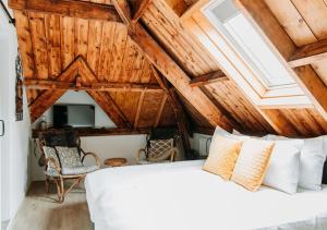 a bedroom with a white bed and wooden ceilings at Bergen1928 in Bergen