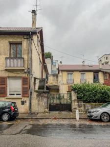 a car parked in front of a building with a gate at Joli T2- cocooning - wifi fibre - lave-linge in Grenoble