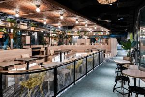 a restaurant with tables and chairs on a balcony at Student Experience Madrid Pozuelo - Luxury Hostel in Pozuelo de Alarcón