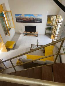 a living room with a couch and a tv at quintal293 in Recife