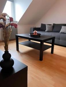 a black coffee table in a living room with a couch at Zentral gelegene Appartement. in Gelsenkirchen