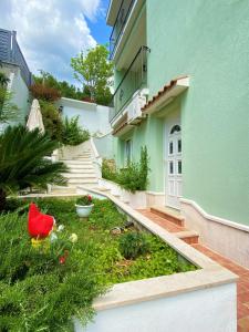 a building with a garden in front of it at HAPPY DAYS in Trogir