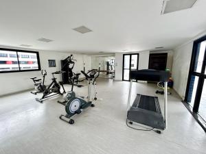 a gym with several exercise bikes and a piano at Apartamento Beira Mar de Pajuçara / Maceió in Maceió