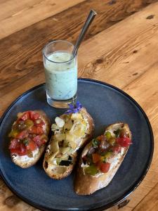 a blue plate with two sandwiches and a glass of milk at Au Pré Fleuri Eco Glamping in Le Lindois