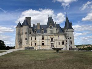 a castle with a bench in front of it at Au Pré Fleuri Eco Glamping in Le Lindois