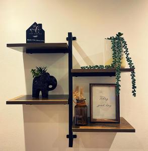 a shelf with a picture and plants on it at 133C HiBrid Home in Oxford