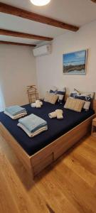 a bedroom with a large bed with blue sheets at Apartment in Njivice/Insel Krk 27855 in Njivice