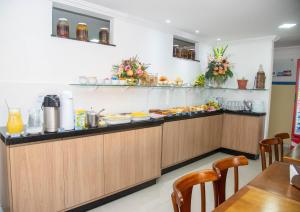 a buffet in a restaurant with food on the counter at Trip Hotel Lauro de Freitas in Lauro de Freitas