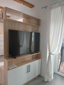 a flat screen tv sitting on top of a entertainment center at Apartment in Njivice/Insel Krk 27855 in Njivice