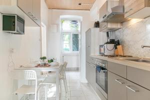 a small kitchen with a table and chairs in it at Neighboring 3 Apts.- Ideal for Families & Friends in Vienna