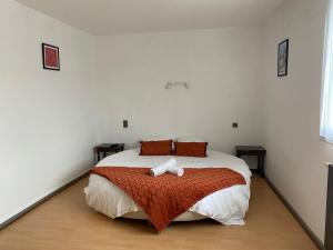 a bedroom with a large bed in a room at L' Auberge Campagnarde, Lourdes in Poueyferré