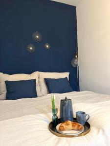 a tray with a plate of food on a bed at The blue VIEcation apartment in Vienna