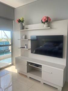 a living room with a large flat screen tv at Apartamento Santa Marta Samaria - 3beds, 4baths, Playa Privada, Cabo Tortuga in Santa Marta