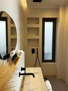 a room with a table and a mirror at On The Rocks Villas Ios in Ios Chora
