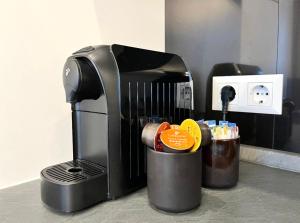 a coffee maker sitting on a counter next to a cup at The blue VIEcation apartment in Vienna