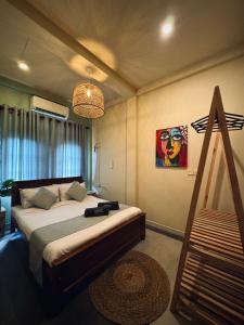 ein Schlafzimmer mit einem Bett und einem Wandgemälde in der Unterkunft Sugar Hostel Weligama - Coliving & Coworking in Weligama