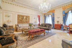 a living room filled with furniture and a chandelier at Napoleon Suite Champs Elysees in Paris