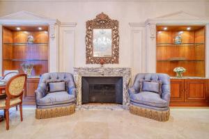 a living room with two chairs and a fireplace at Napoleon Suite Champs Elysees in Paris +36 photos