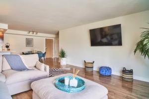 a living room with a couch and a table at Marina Magic: Seaside Sanctuary With Marina Views! in Los Angeles