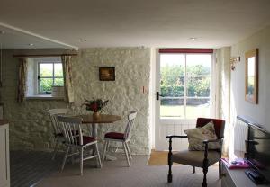 a living room with a table and chairs at Dee's Cottage at Brinsop in Hereford