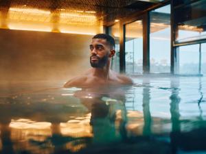 Ein Mann im Wasser im Schwimmbad. in der Unterkunft Clarion Hotel Stockholm in Stockholm