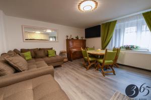 a living room with a couch and a table at 365 Guest House in Hunedoara