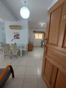a room with a table and chairs and a door at Sunny 2 Bedroom Larnaca Center in Larnaka
