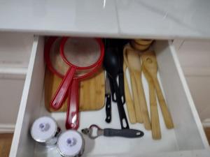 a drawer filled with cooking utensils in a cabinet at Acogedor Departamento Central in Loja