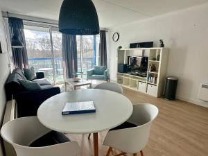 a living room with a white table and chairs at Appartement Badhotel 325 in Callantsoog