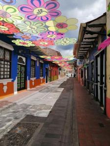 an empty alley with flowers painted on the ceilings at Acogedor Departamento Central in Loja