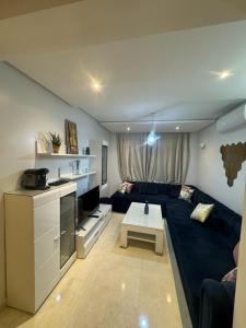 a living room with a couch and a table at Coralia Haut Standing Appart f2 in Oujda