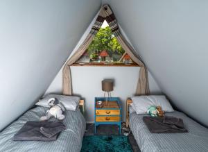 a bedroom with two beds and a window at Chalet Thirteen in Deal