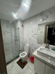 a bathroom with a toilet and a shower and a sink at Coralia Haut Standing Appart f2 in Oujda +7 photos
