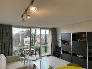a living room with a couch and a table at Malgré Tout 0207 in Koksijde