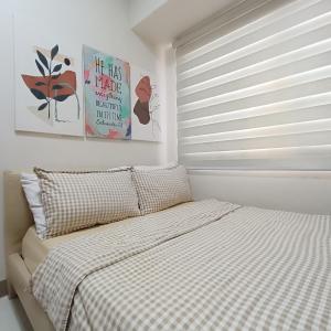 a bedroom with a bed and a window with blinds at SMDC Coast Residences near PICC World Trade Center MOA in Manila